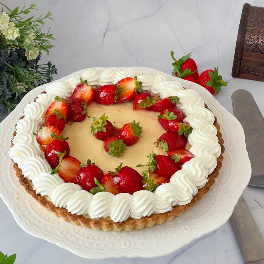A cake stand with pastry cream and whipped cream.