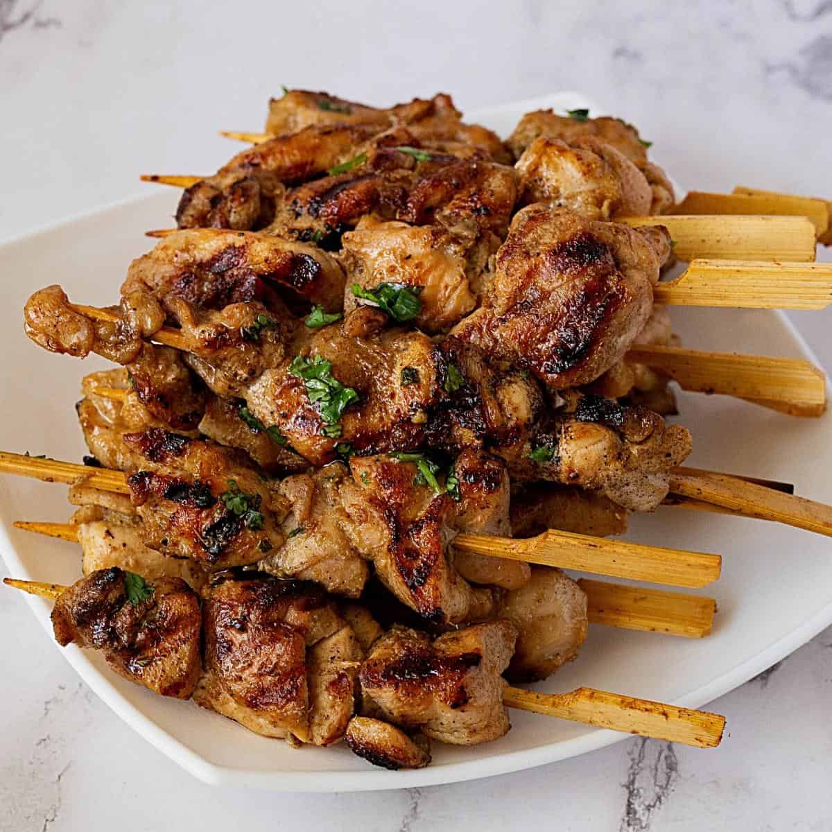 A platter with thai skewers.