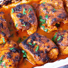 A baking dish with curried chicken baked.