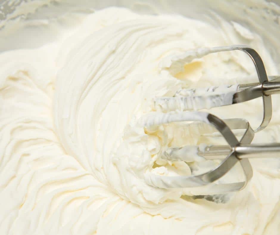 Whipping cream in a stand mixer.