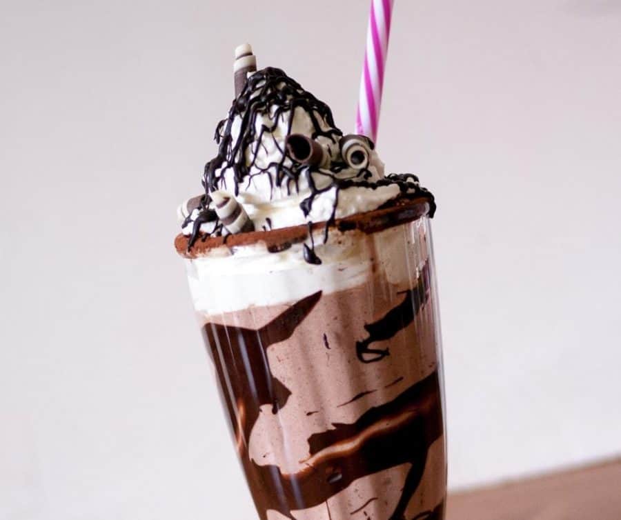 A cold Chocolate drink with whipped cream on top.
