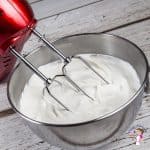 Whipping cream in a stand mixer.