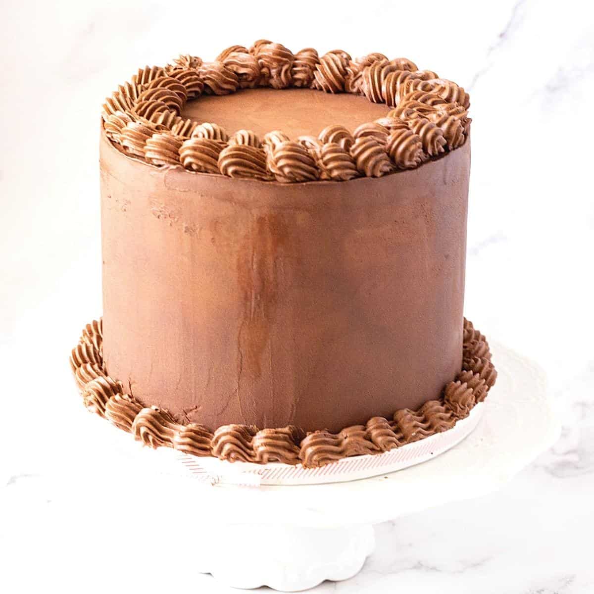 A cake frosted with whipped chocolate ganache.