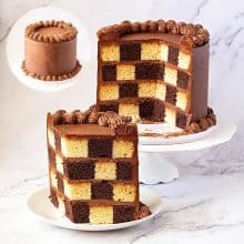 A layer cake with checkerboard effect on the table.