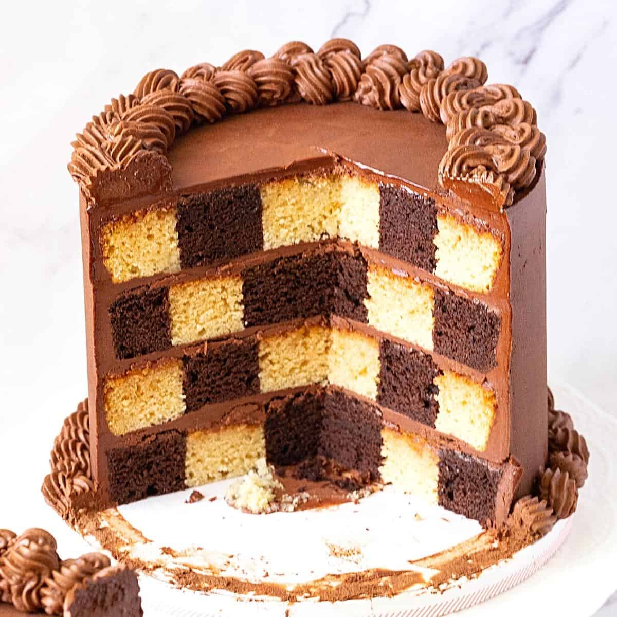 A sliced checkerboard cake on the table.