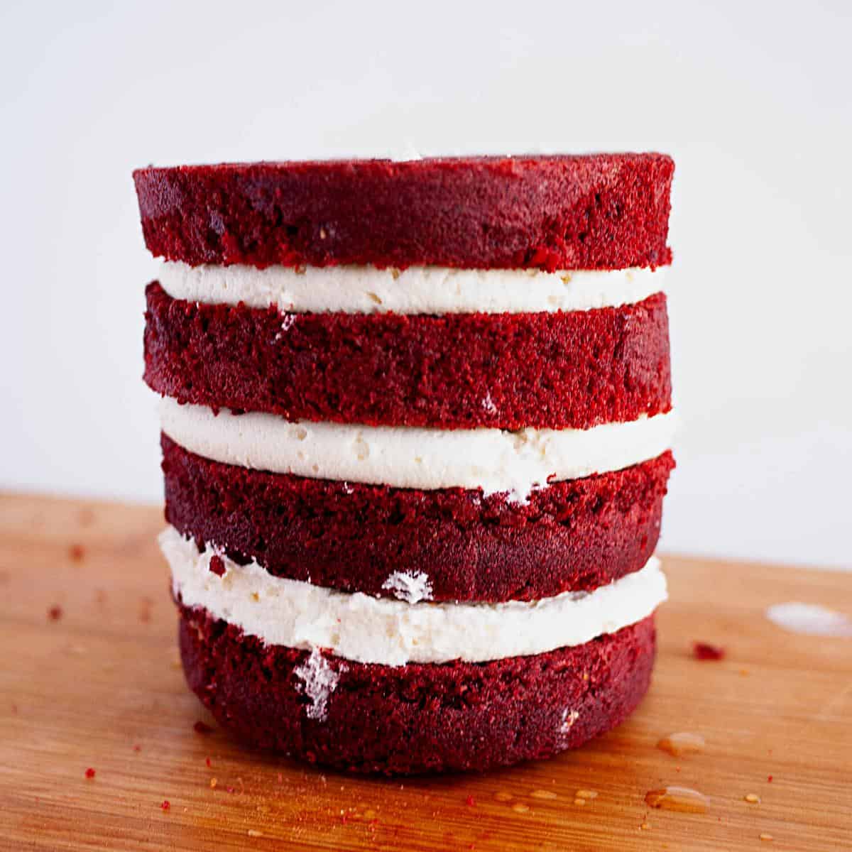 Four layers of frosted red velvet cake.