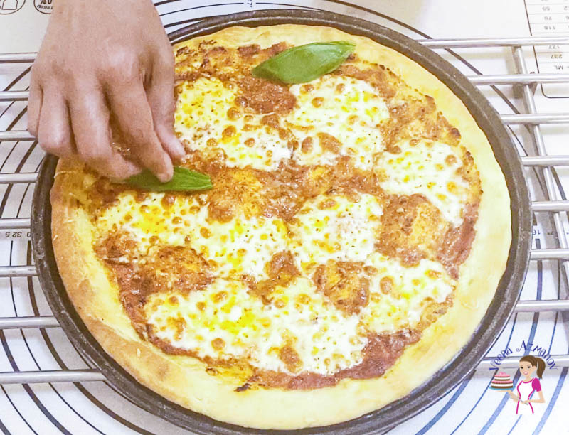 Bake the pizza crust until the edges are golden