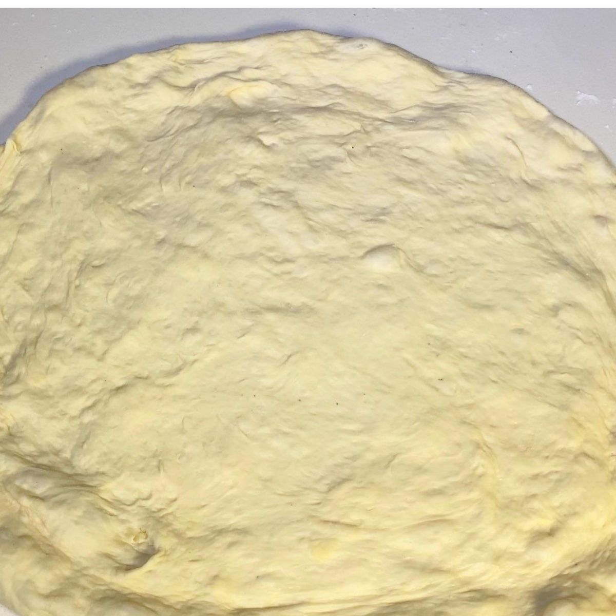 Stretching the pizza dough for baking.