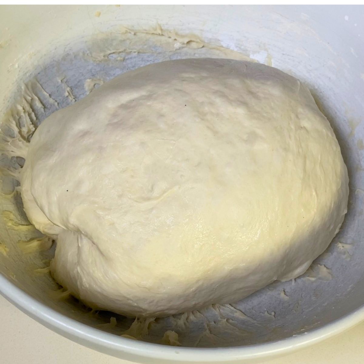 Doing stretch and fold for pizza dough.