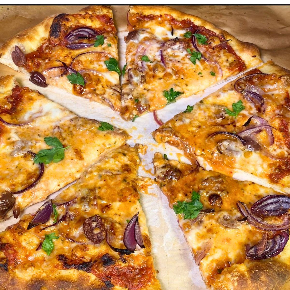 Sliced olive pizza on table.