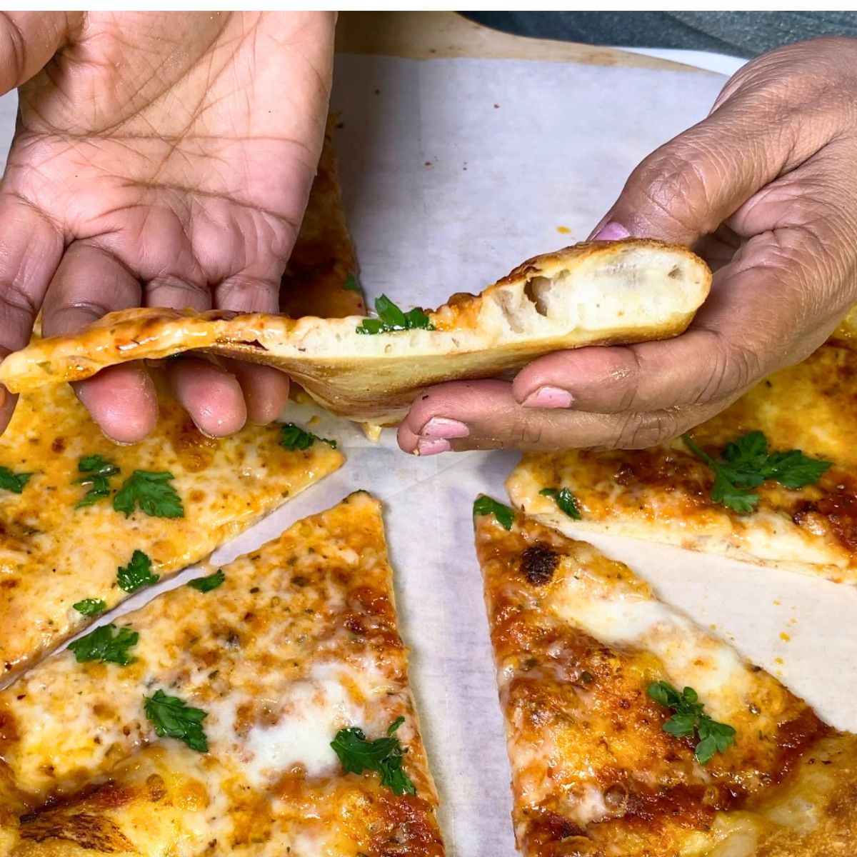 Thin crust pizza slice showing crust.