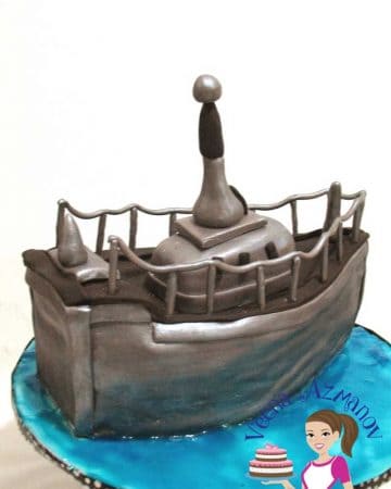 A cake decorated like a navy boat.