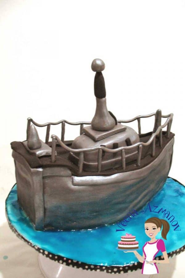 A cake decorated like a navy boat.
