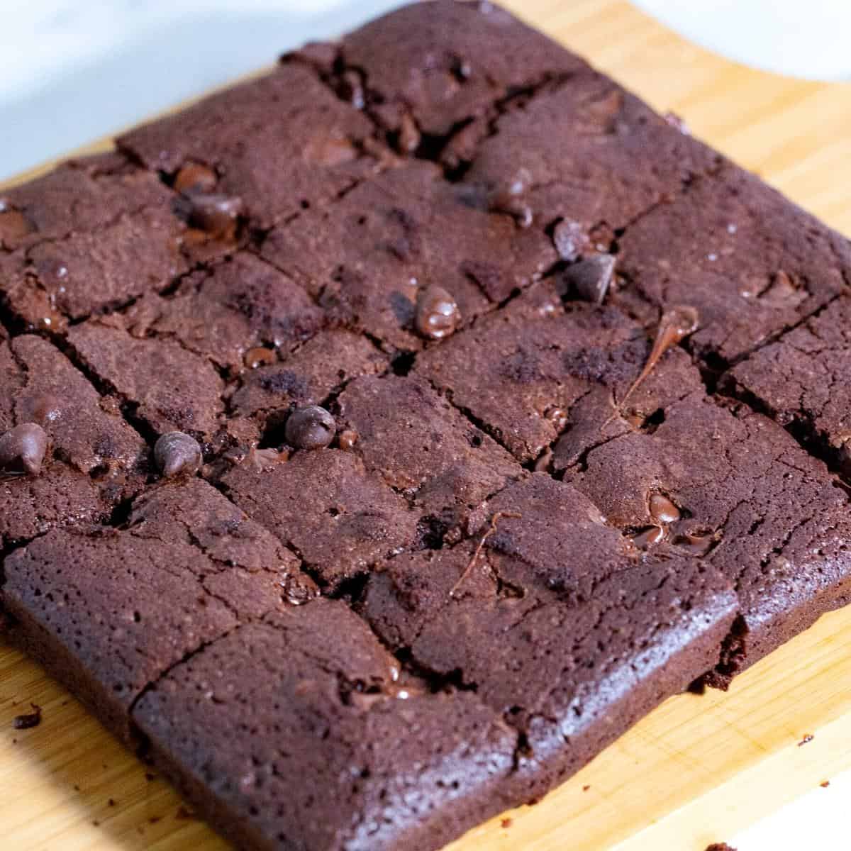 A slab of sliced brownies on a the table.
