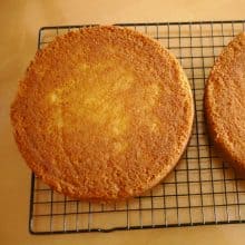 Vanilla cake on a cooling rack.