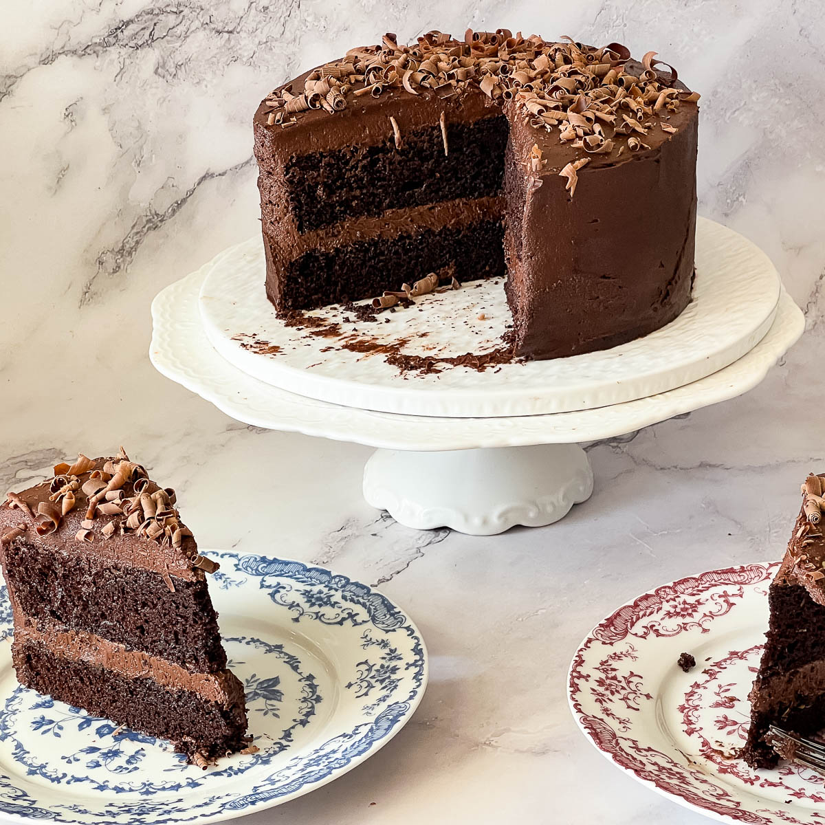 A sliced cake on the cake stand and plate.