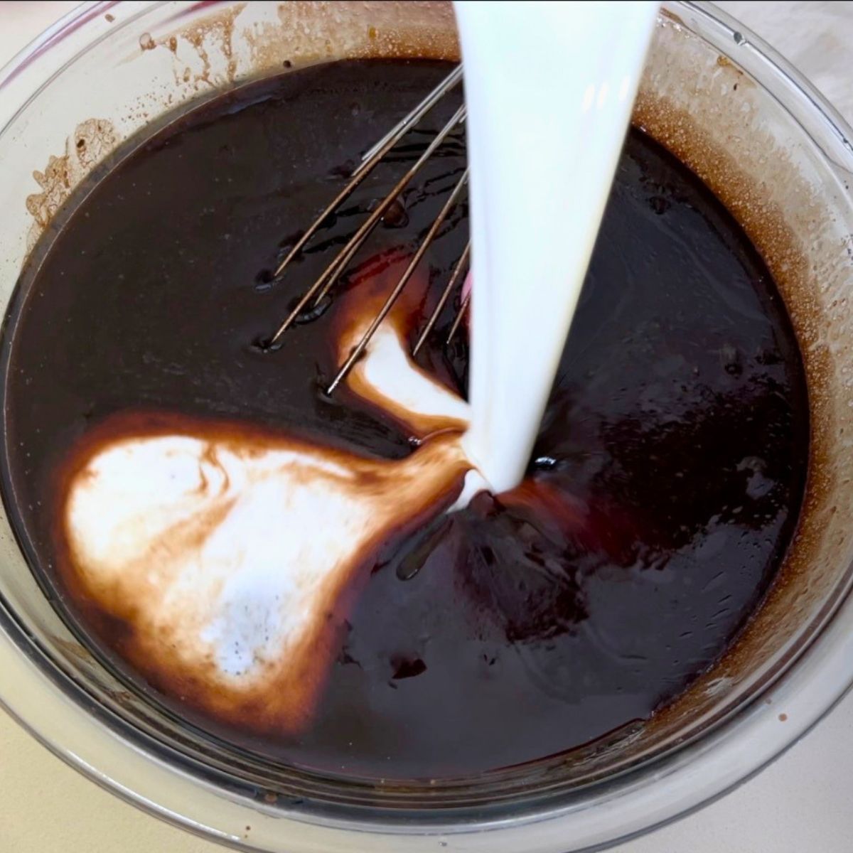 Adding buttermilk to the chocolate batter.