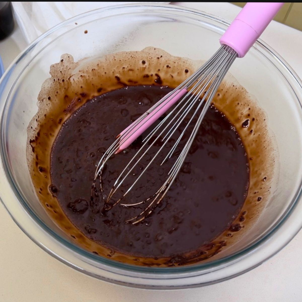 A glass bowl with coffee and cocoa powder.