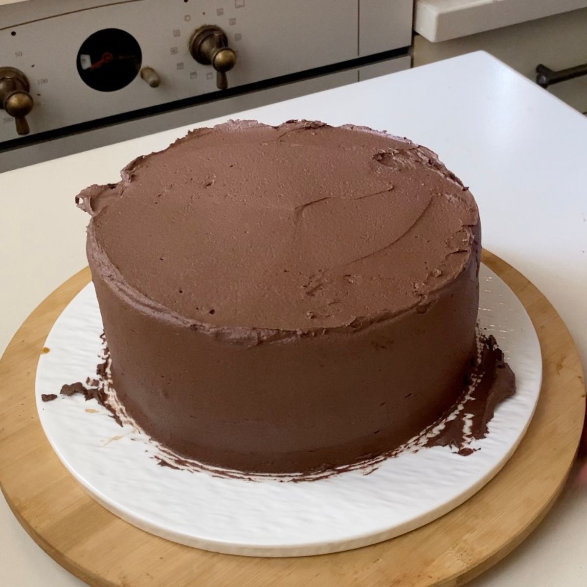 Frosting a cake with chocolate cake.
