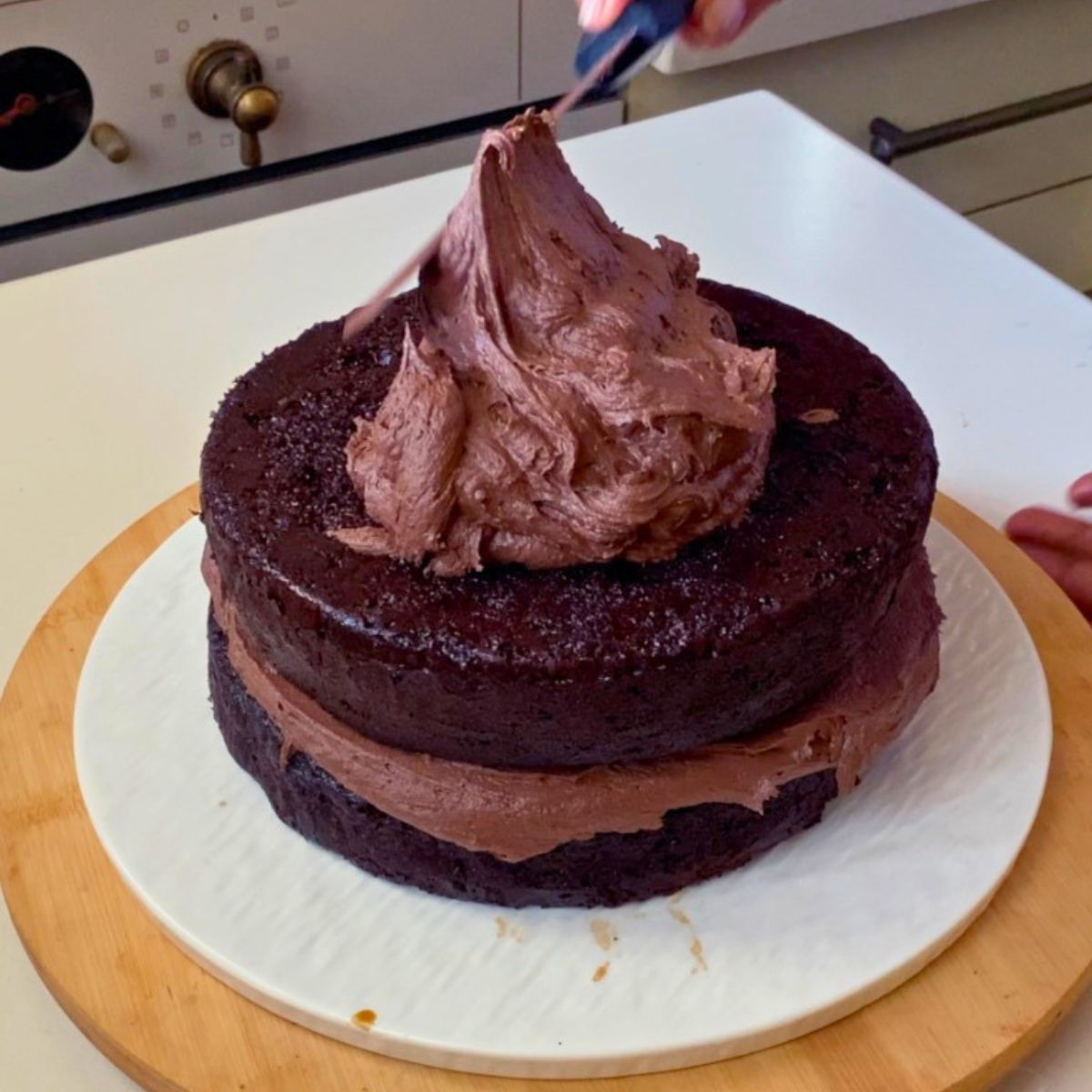 Frosting a one bowl chocolate cake.