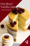 A sliced vanilla layer cake with cherries on top.