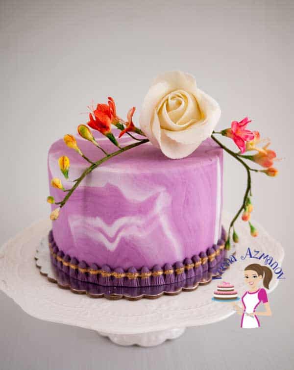 A cake decorated with a marble design fondant.