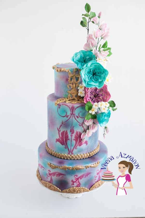 A decorated cake with gum paste flowers.
