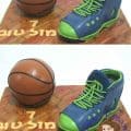 A cake decorated like a basketball and a shoe.