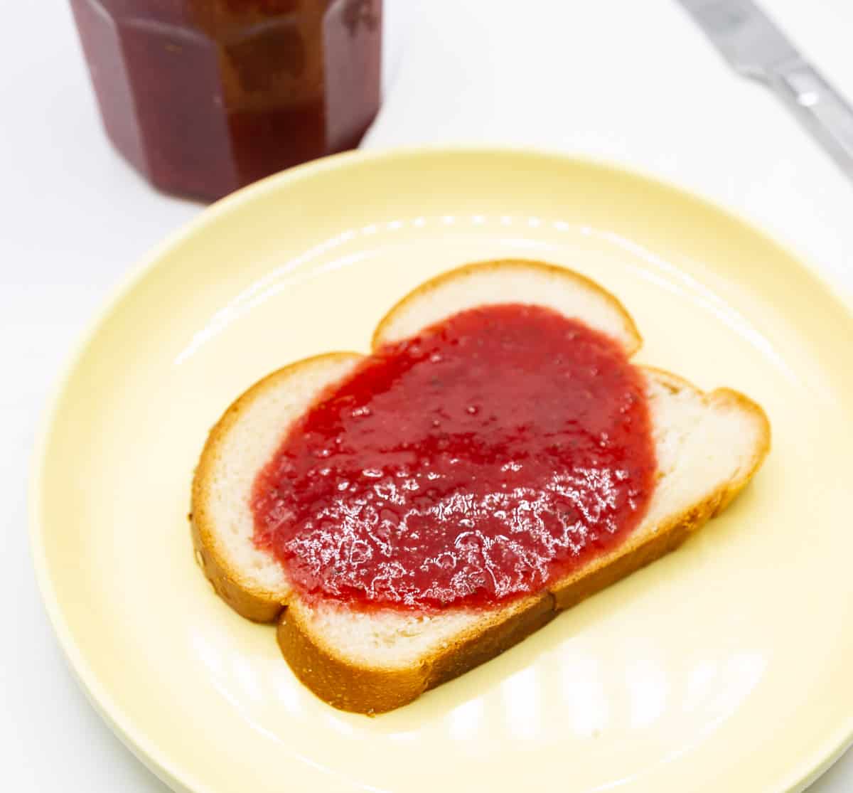 A slice of bread with strawberry jam.