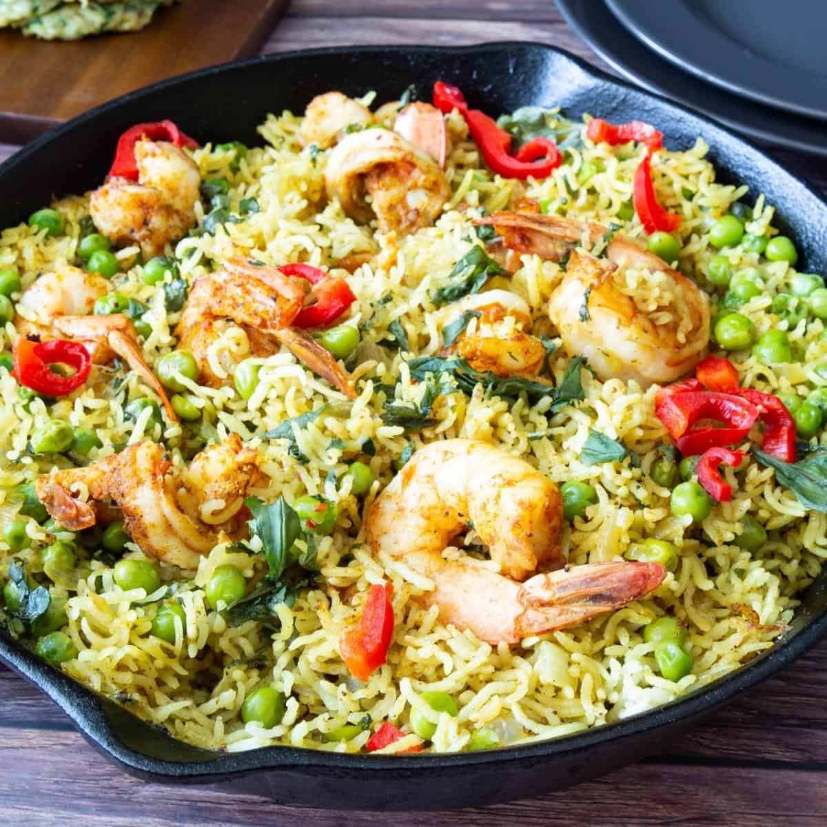 Skillet with cooked rice and prawns.