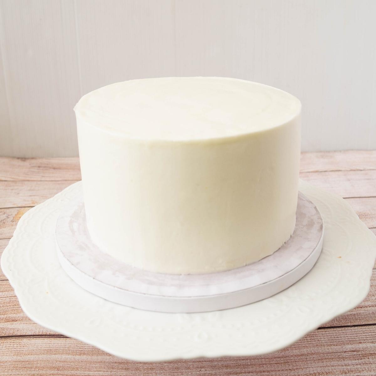 A buttercream frosted cake with sharp edges.