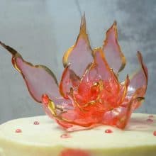 An isomalt flower on a cake.
