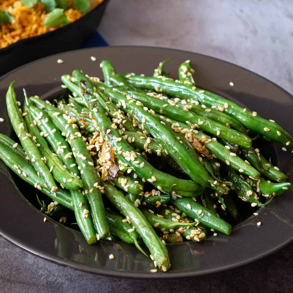 A plate with green beans and sesame seeds