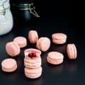 Strawberry macarons on a table.
