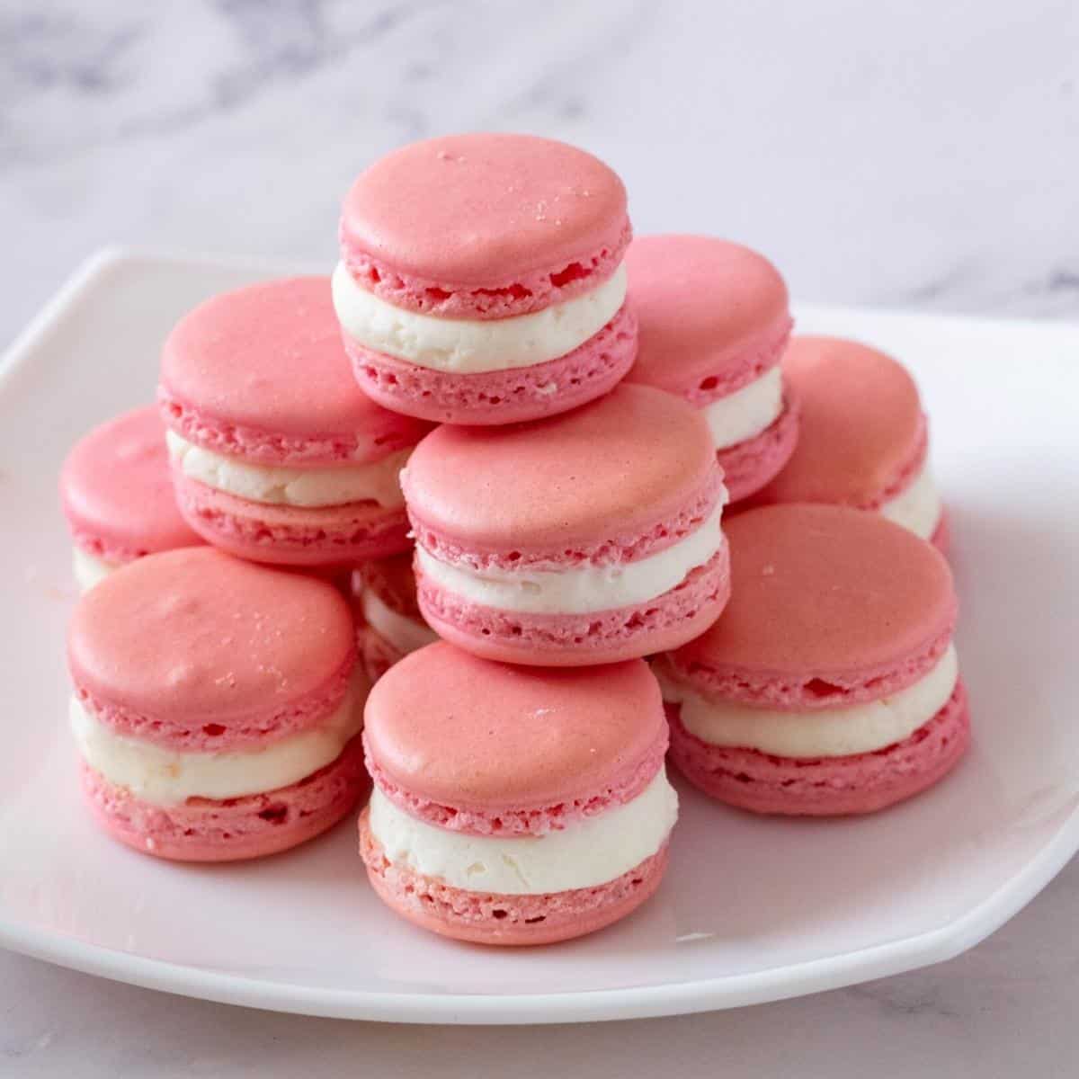 A stack of strawberry pink french macarons.