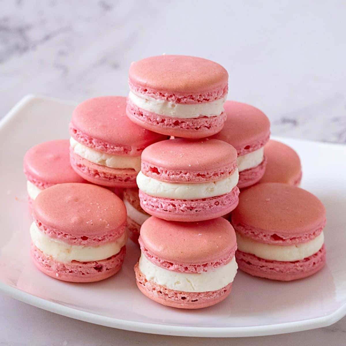 A white plate with French Strawberry Macarons