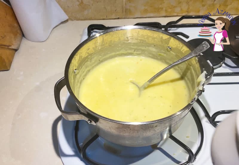 A pot of soup sitting on a stove top.