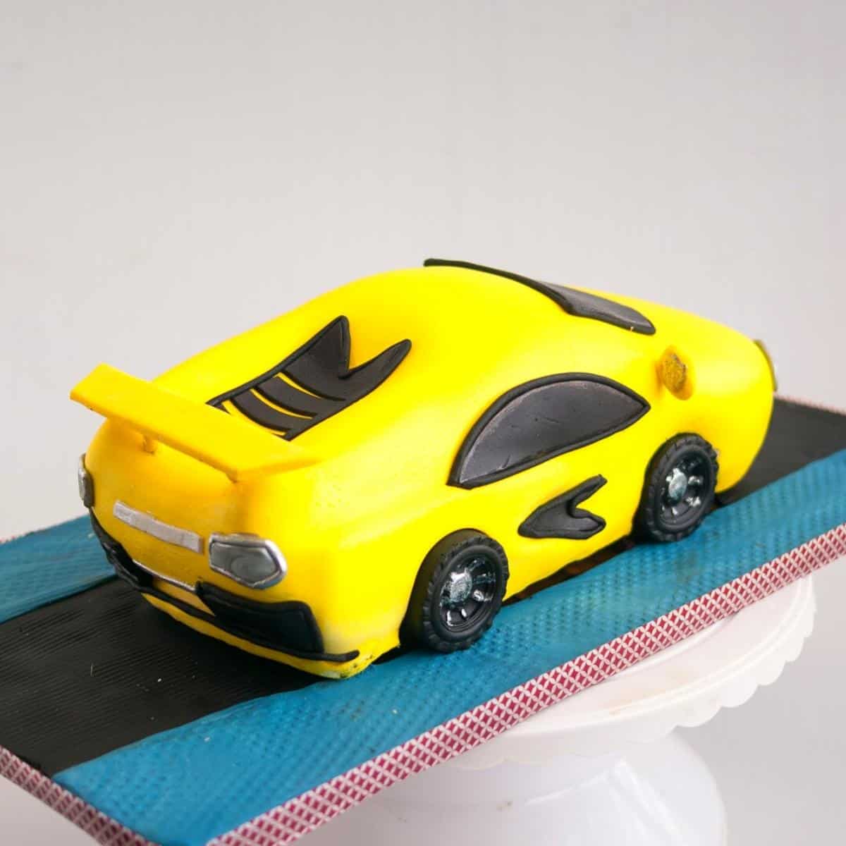 A cake board with cake shaped as a car.