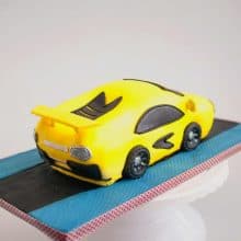 A yellow cake on a cake board.