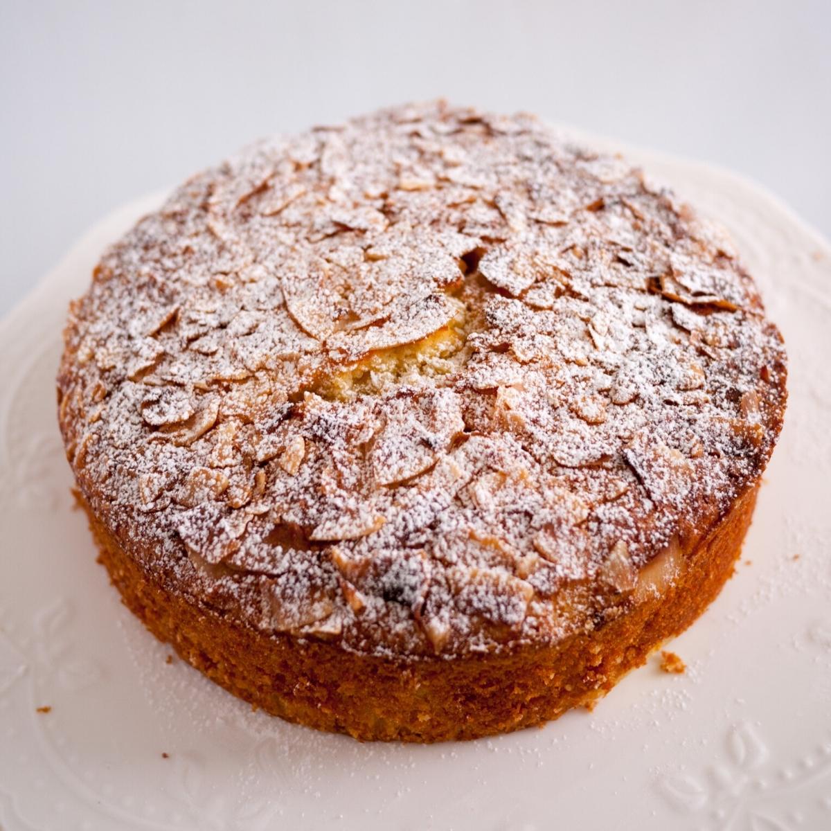 A coconut coffee cake dusted with powdered sugar.