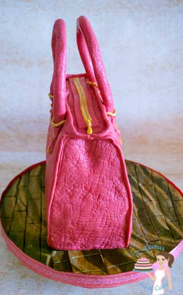 Pink Hand Bag Cake - A Hand bag cake is a perfect cake to make for a lady of any age. Depending on the age you can tweak the colors, accessories and style. Great Tutorial by Veena Azmanov of Veena's Art of Cakes
