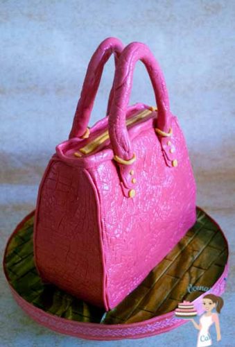 A cake decorated to look like a lady\'s handbag.