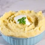 A blue bowl with mashed potatoes.