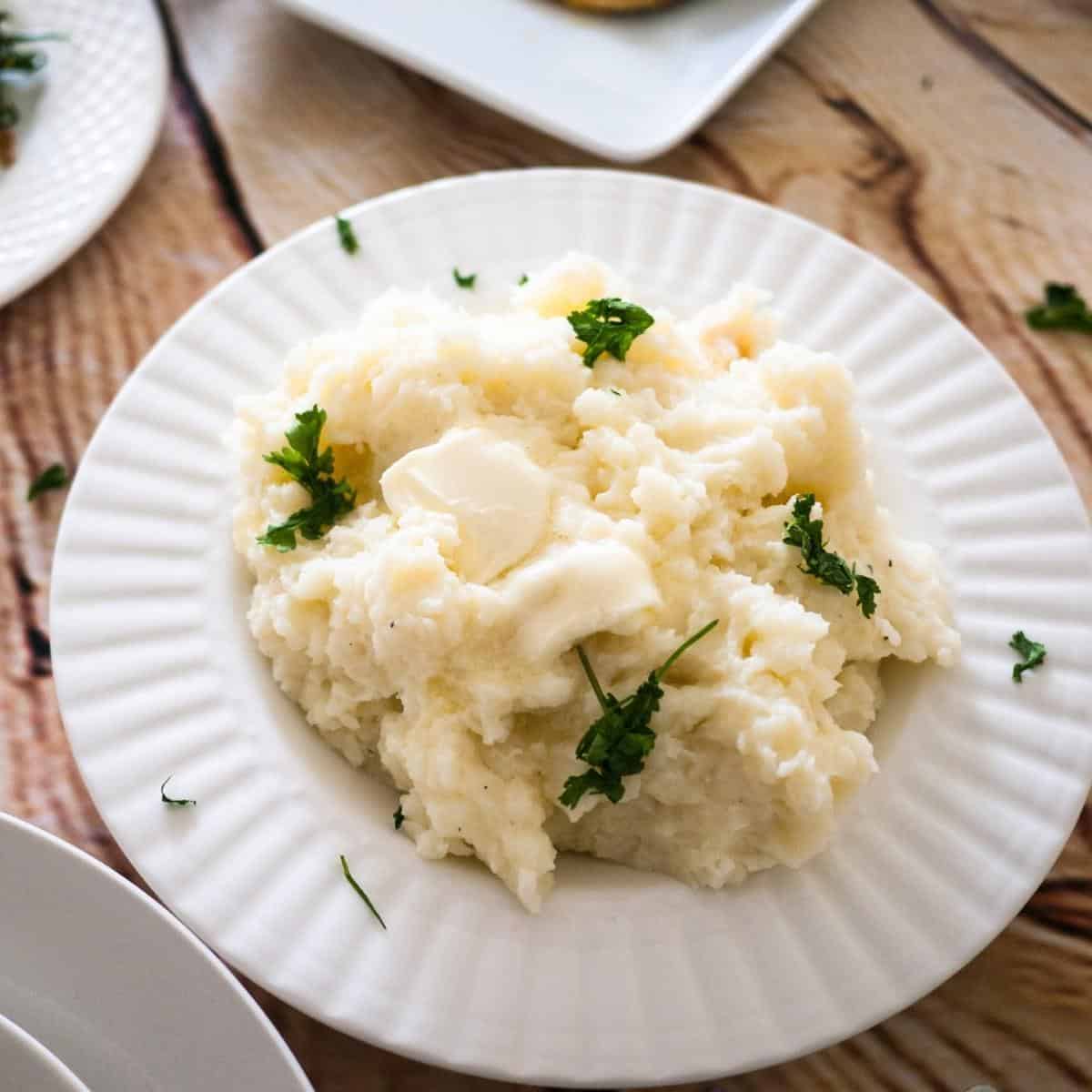 A white plate with mashed potato