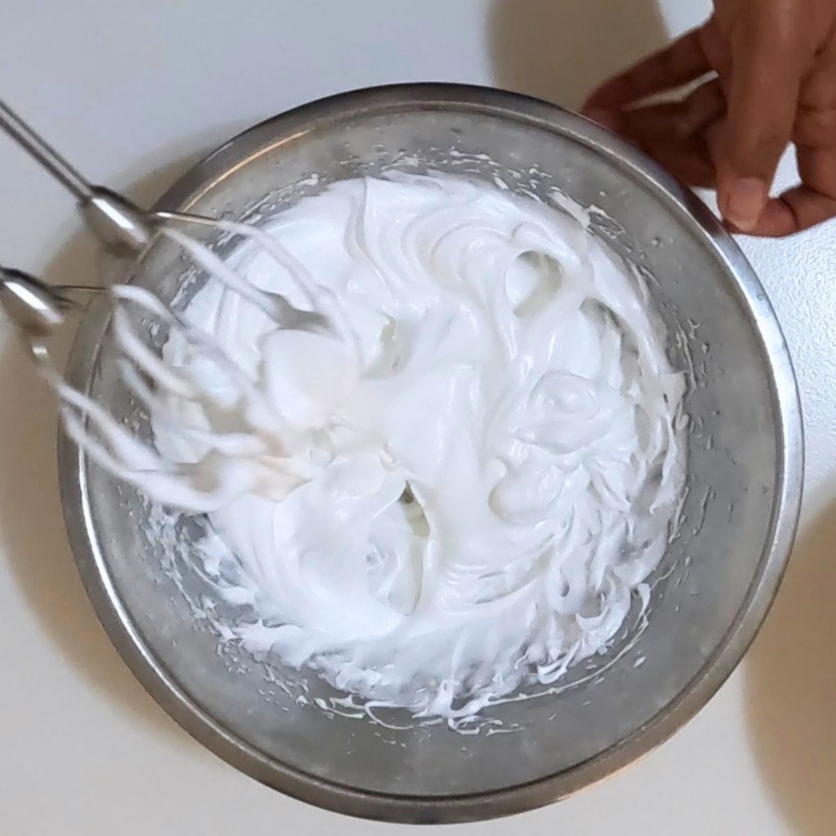 Whipping the egg whites to meringue.