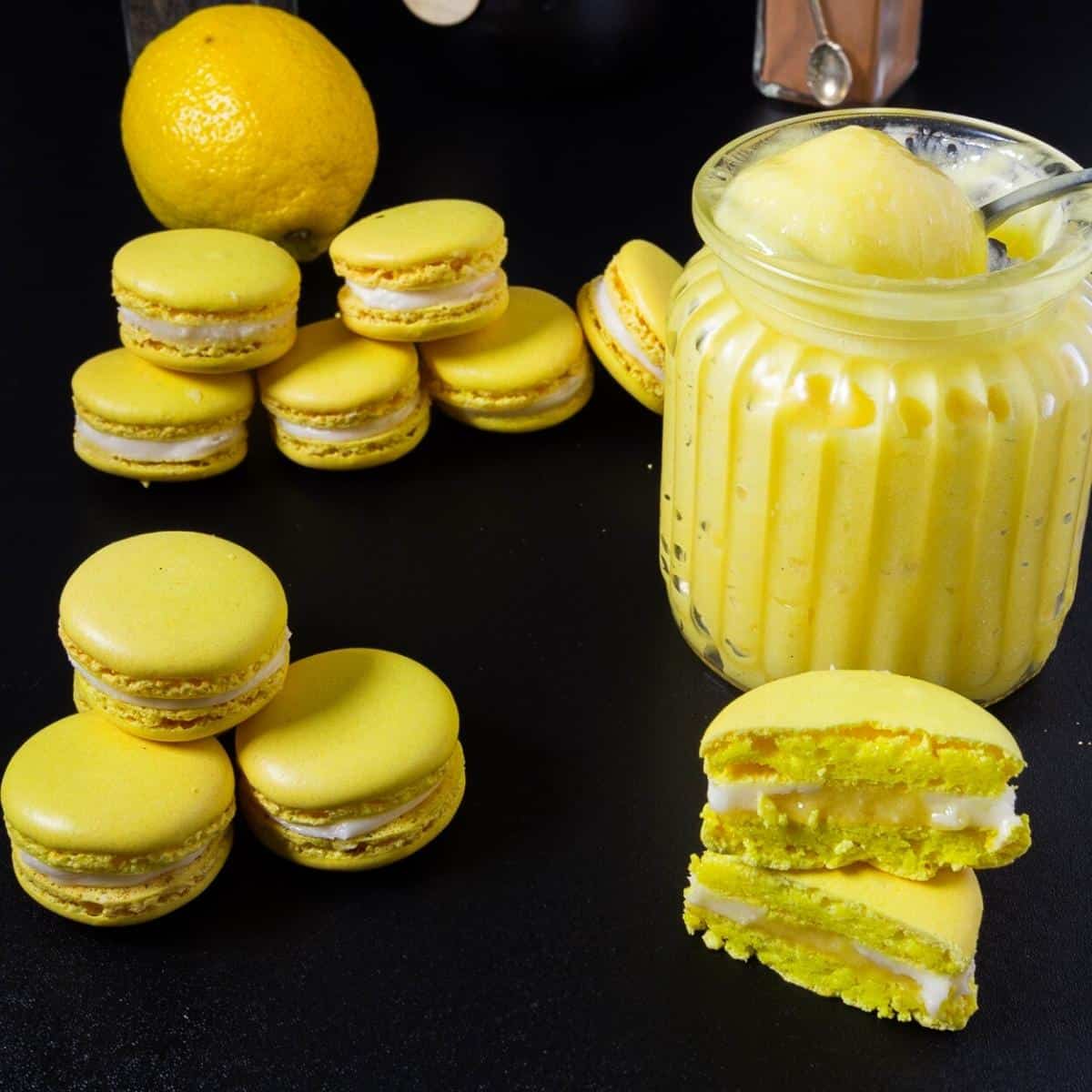 Lemon macarons with lemon curd on the table.