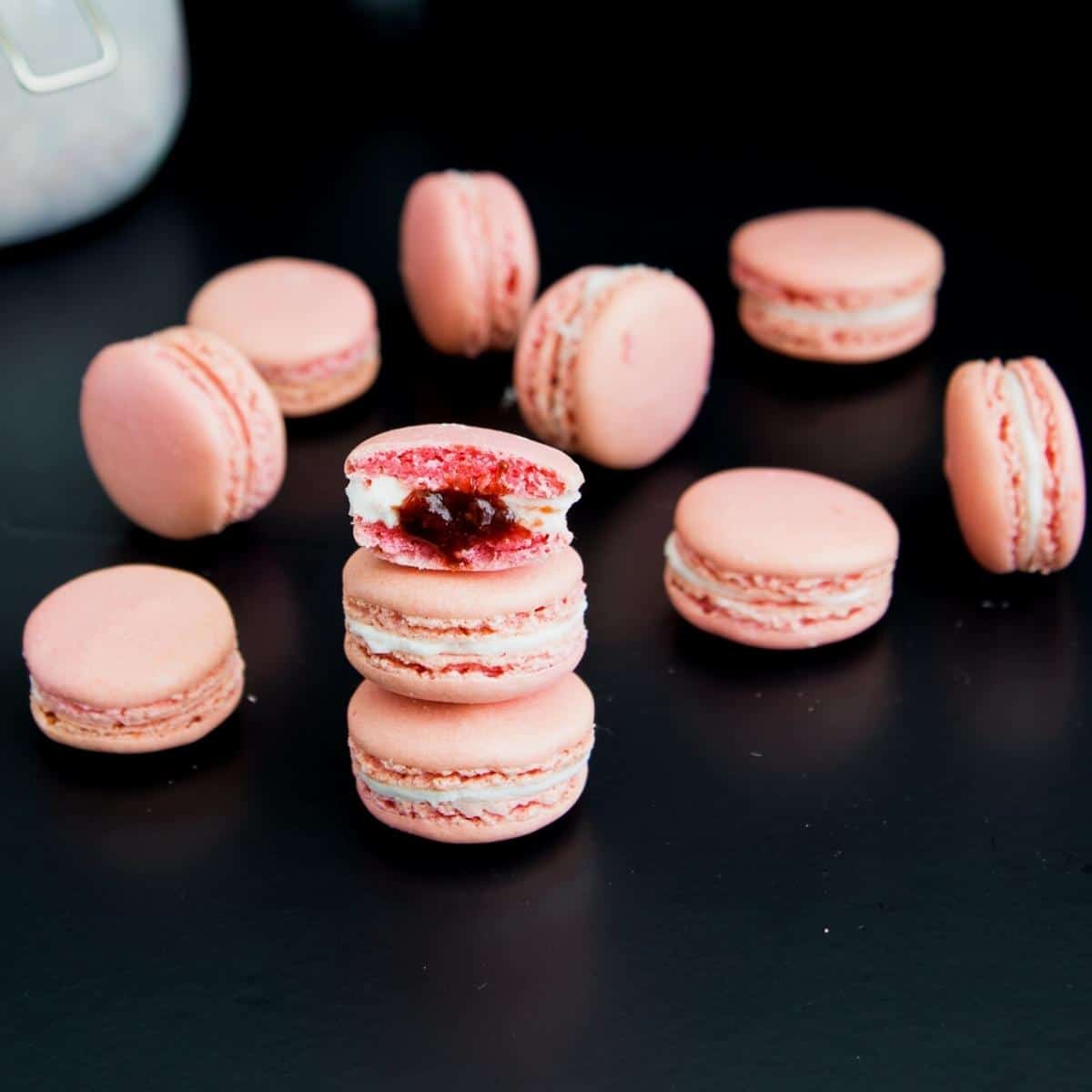 Stack of strawberry macarons on the table.