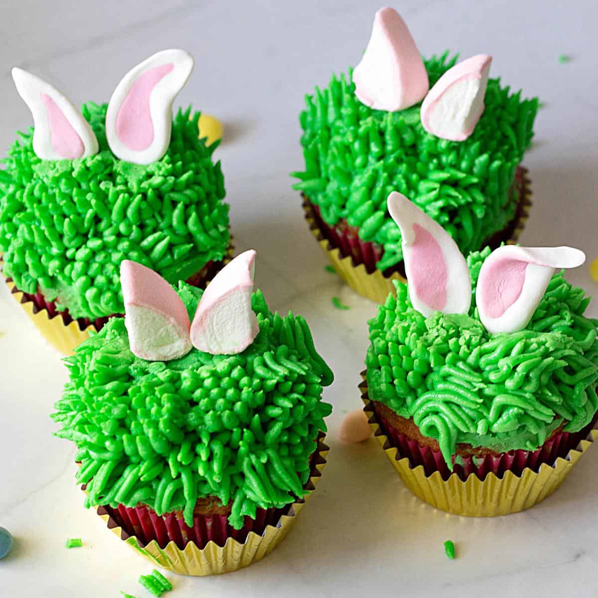 Cupcakes with grass frosting and bunny ears.