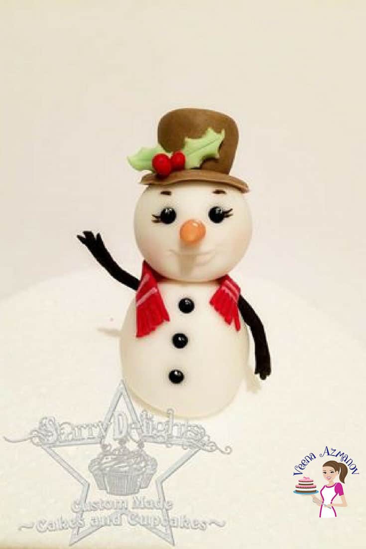A cake decorated to look like a snowman.