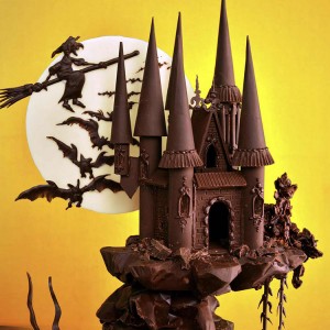 A cake sculpted to look like a spooky castle.